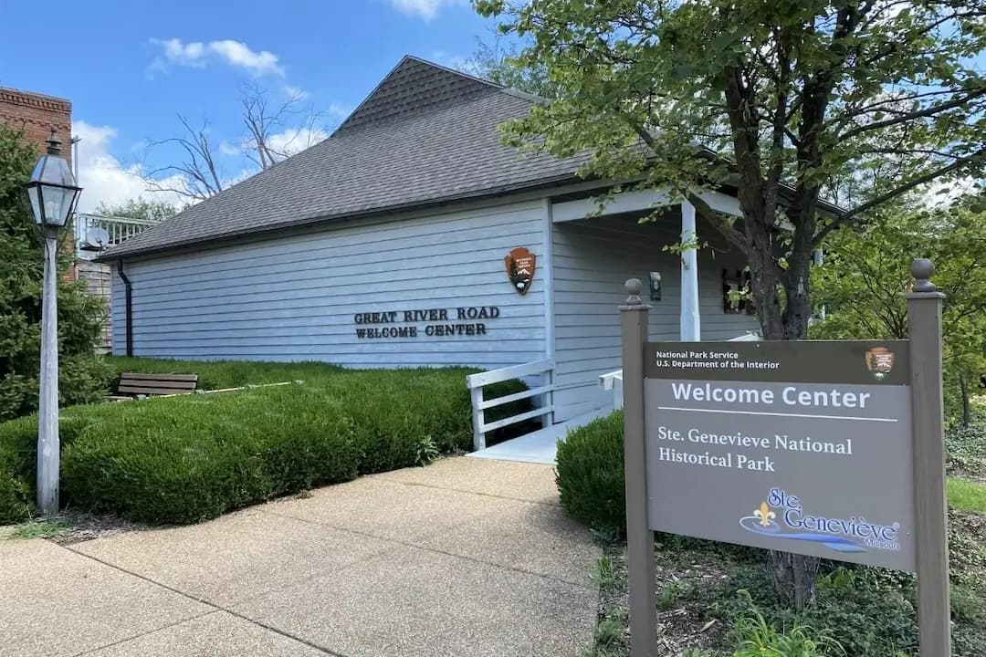 A welcome center for Ste. Genevieve National Historical Park, featuring a sign and landscaped surroundings.